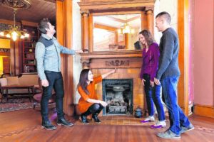 Amy and Doug Heavilin, right, talk about the fireplace of their 1902 Victorian home in Franklin with Elizabeth and Ethan Finkelstein, hosts of HGTV's "Cheap Old Houses," during filming for the show on Jan. 21. The Heavilins will be featured in an episode of the show streaming on Aug. 16 on discovery+ and Aug. 23 on HGTV. Submitted photo.