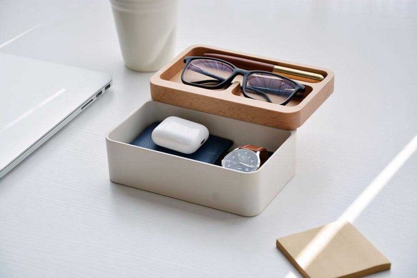 box with rotating wooden lid holding glasses, a watch and AirPods