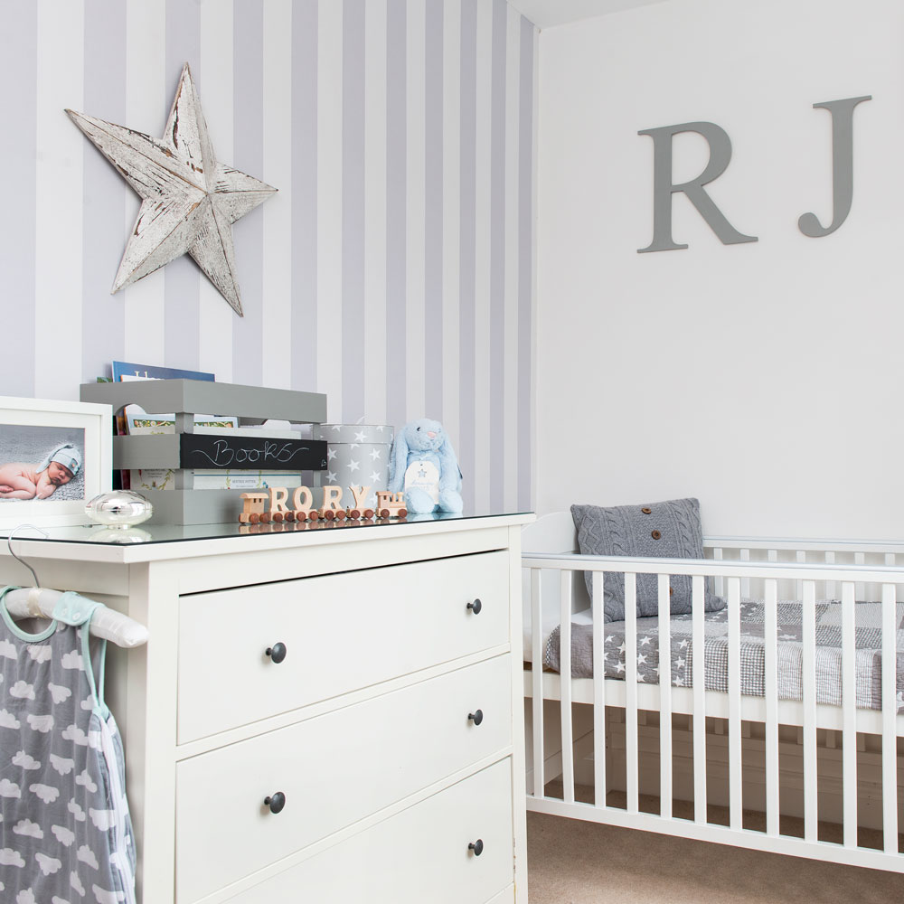 Grey striped nursery wallpaper and personalise wooden letters on white wall