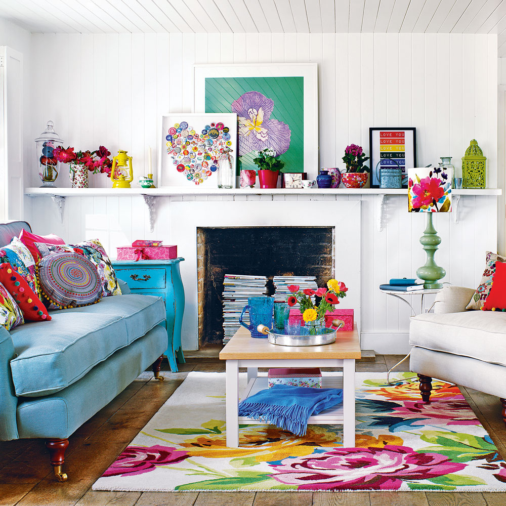 white living room with fireplace place and colourful rug and wall art and blue sofa