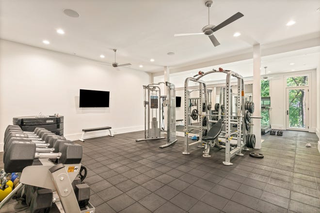 This custom home by Grove Park Construction shows the level of commitment some homeowners are going to for their home gym experience. Notice the gym flooring, direct access to the outdoors and ample room for weight racks and additional fitness equipment.