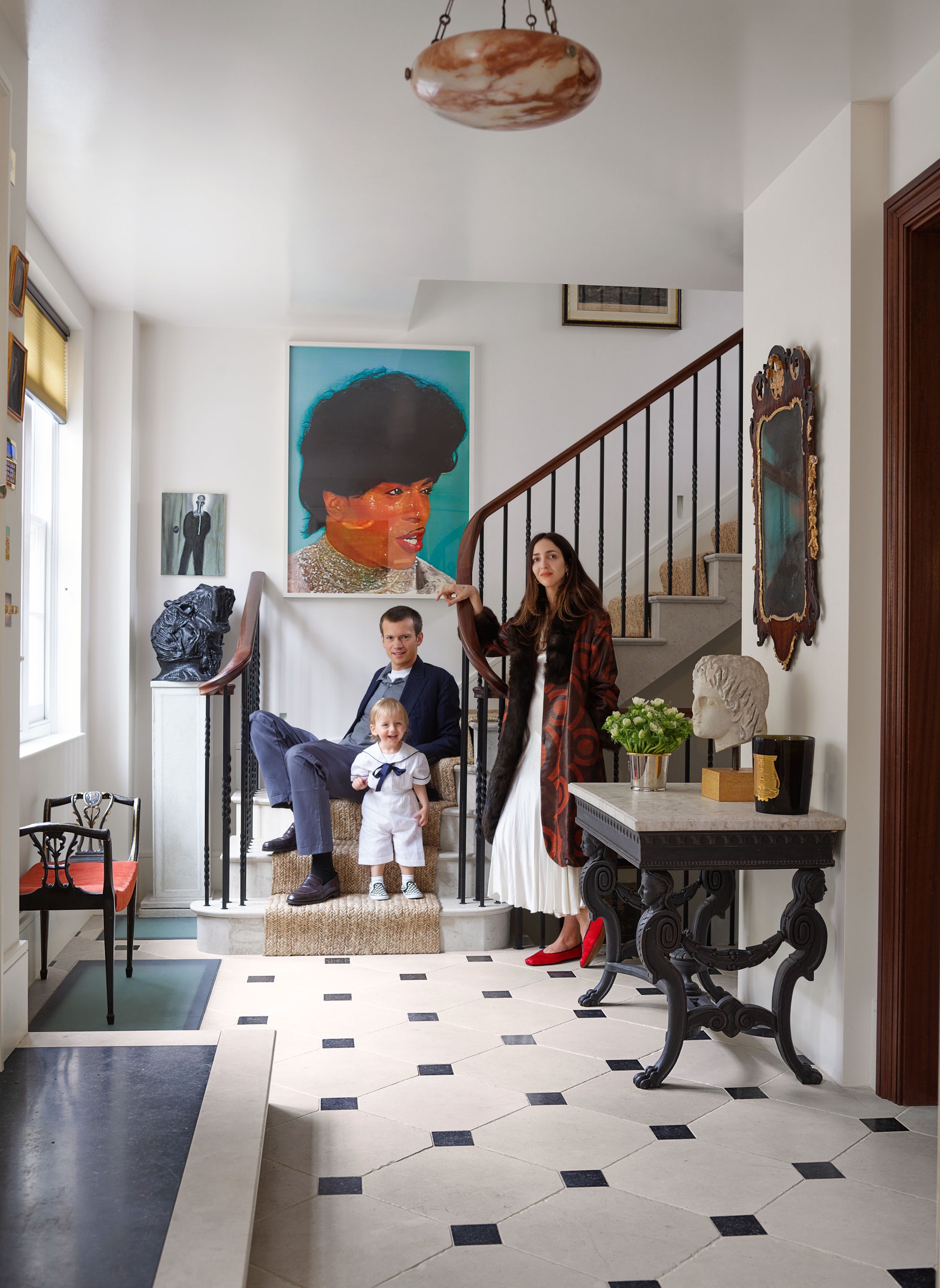 Guinness Weinstock and son Reuben in the entrance hall. The portrait of Little Richard is by Mark Leckey.